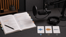 An open manuscript beside a microphone, with small waveform swatches suggesting different narrator tone choices.
