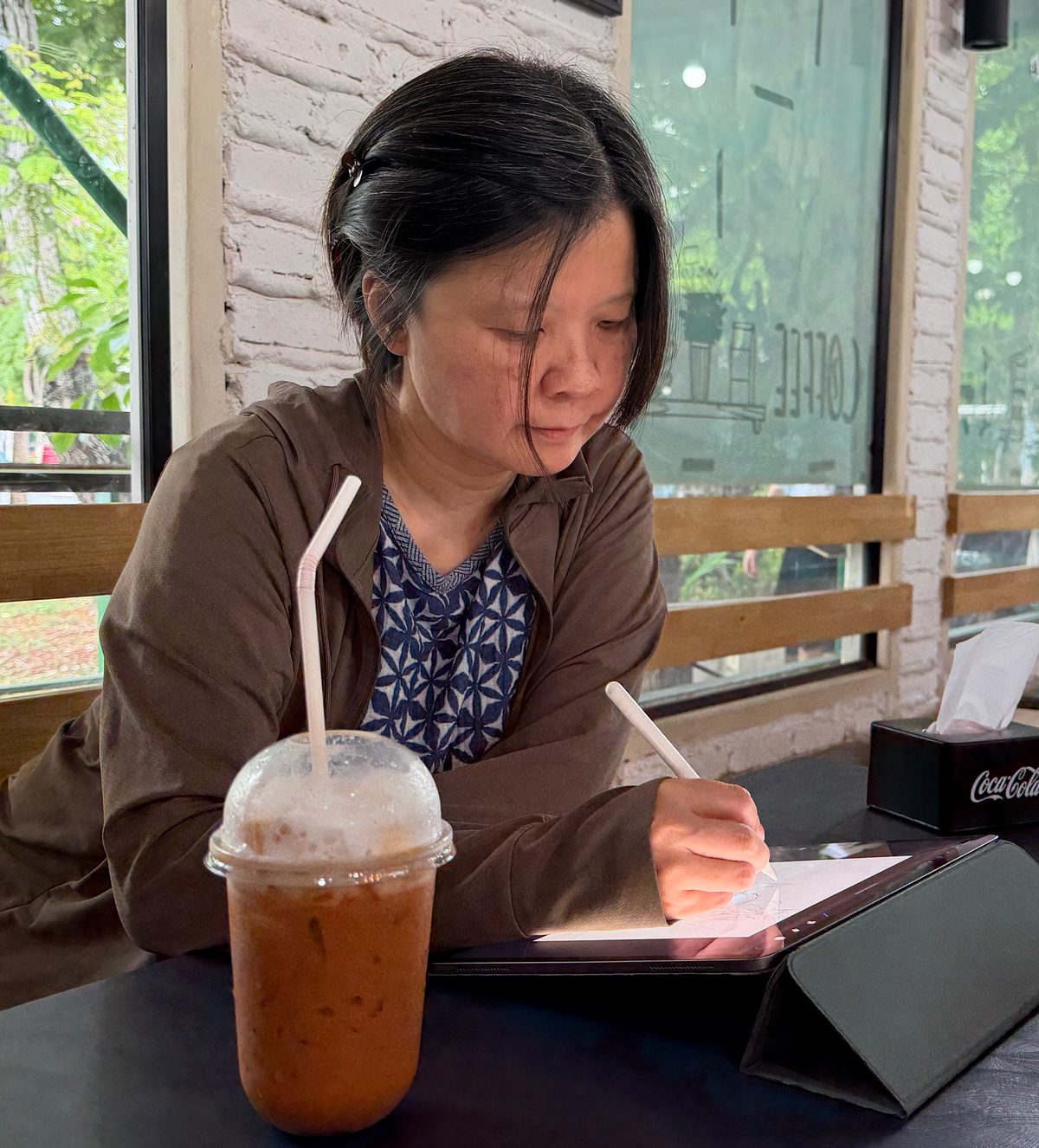 Jern sketching over Thai iced tea in Bangkok.